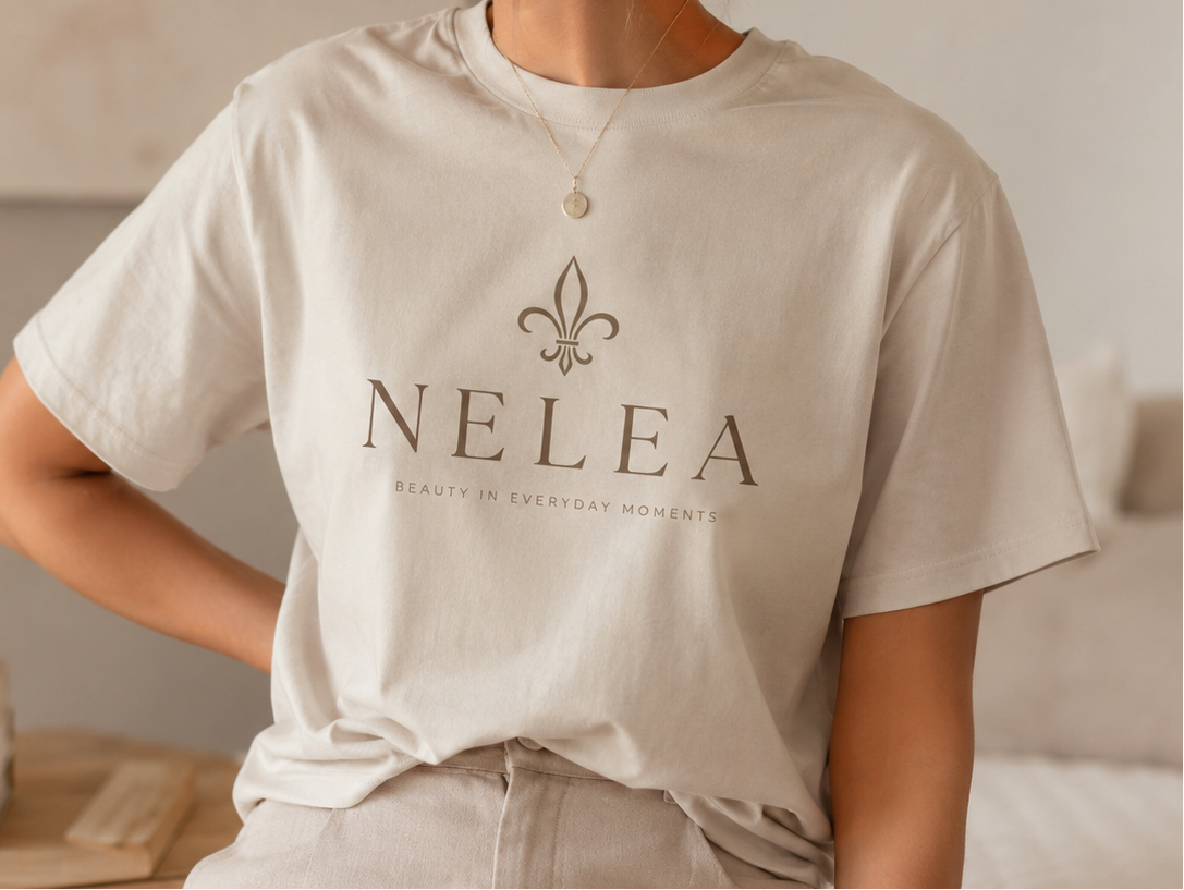 Person wearing a beige t-shirt with 'NELEA' branding in a casual setting. match the heading
